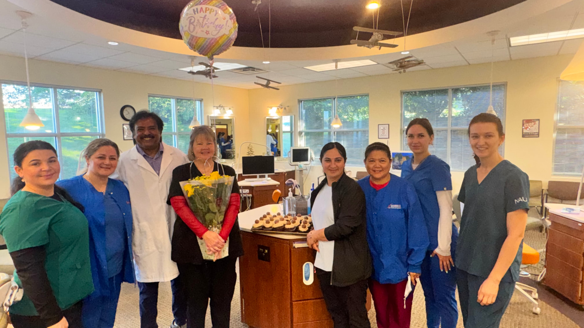 Dr. Raj Kulkarni and the Kulkarni Orthodontics team celebrating together in the office