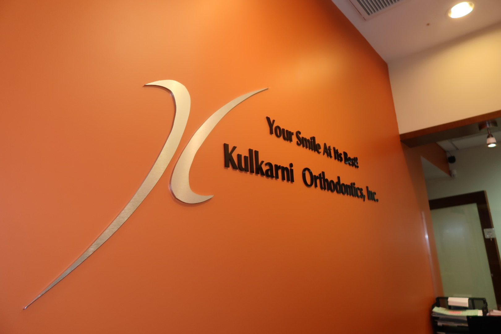 Kulkarni Orthodontics brand wall — Your Smile At Its Best